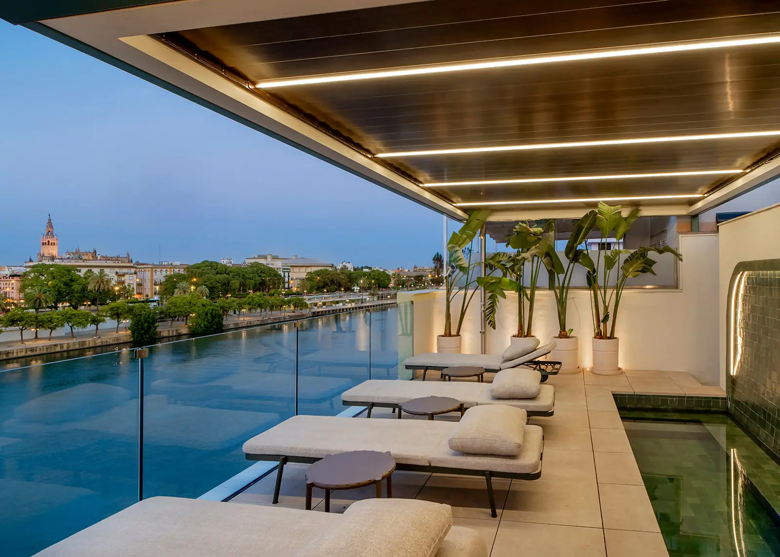 Terraza de CasaKary con tumbonas y el Guadalquivir al anochecer